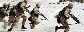 soldiers running with machine guns