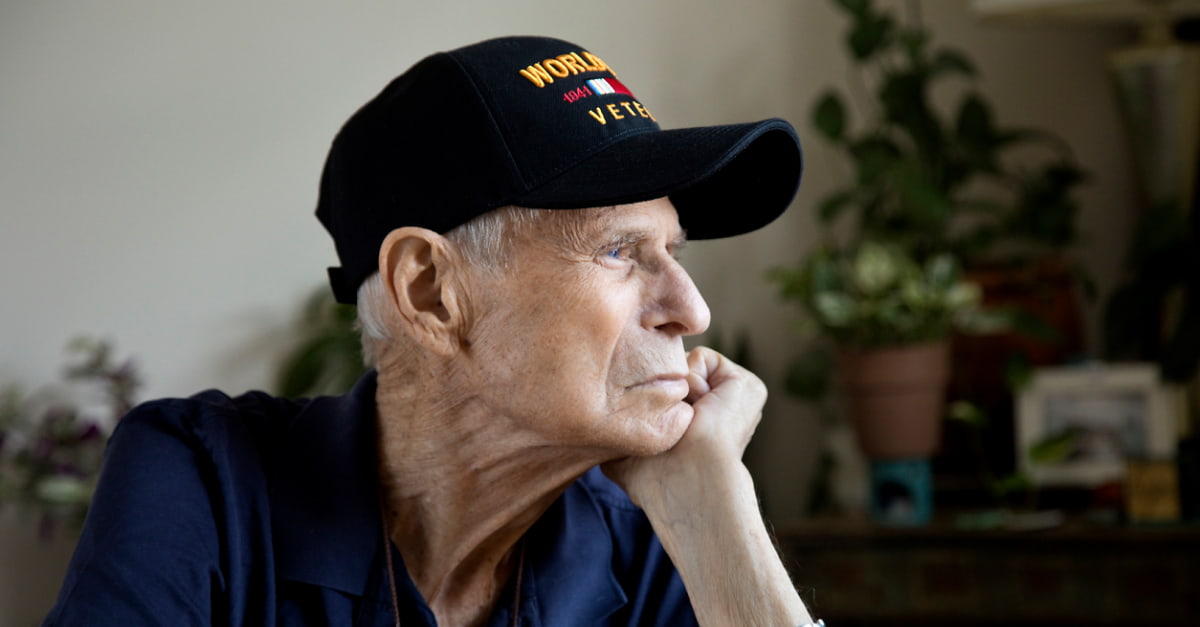 An older U.S. veteran looking pensive