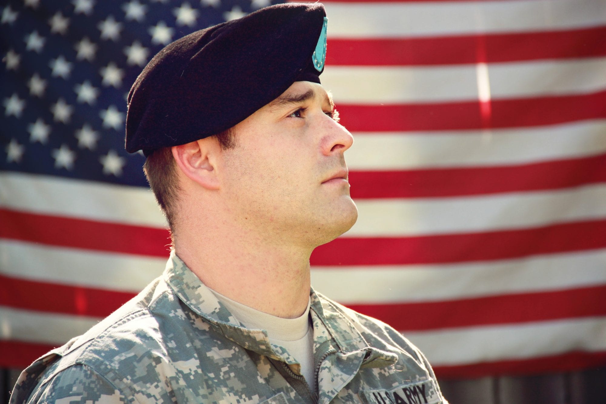 a veteran in front of american flag