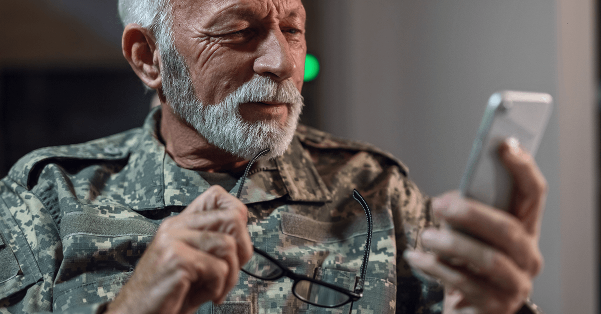 military veteran looking at cellphone