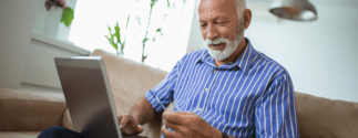 elderly man looking at a laptop
