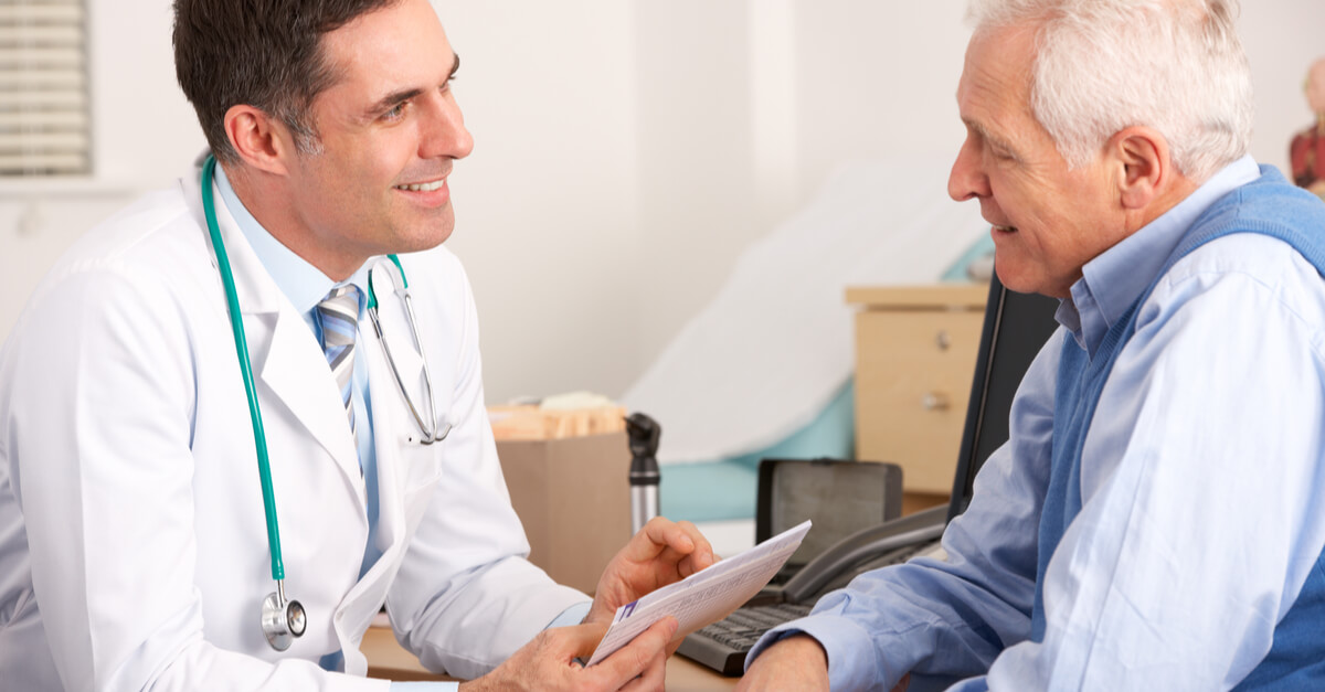 a doctor meets with an elderly male patient