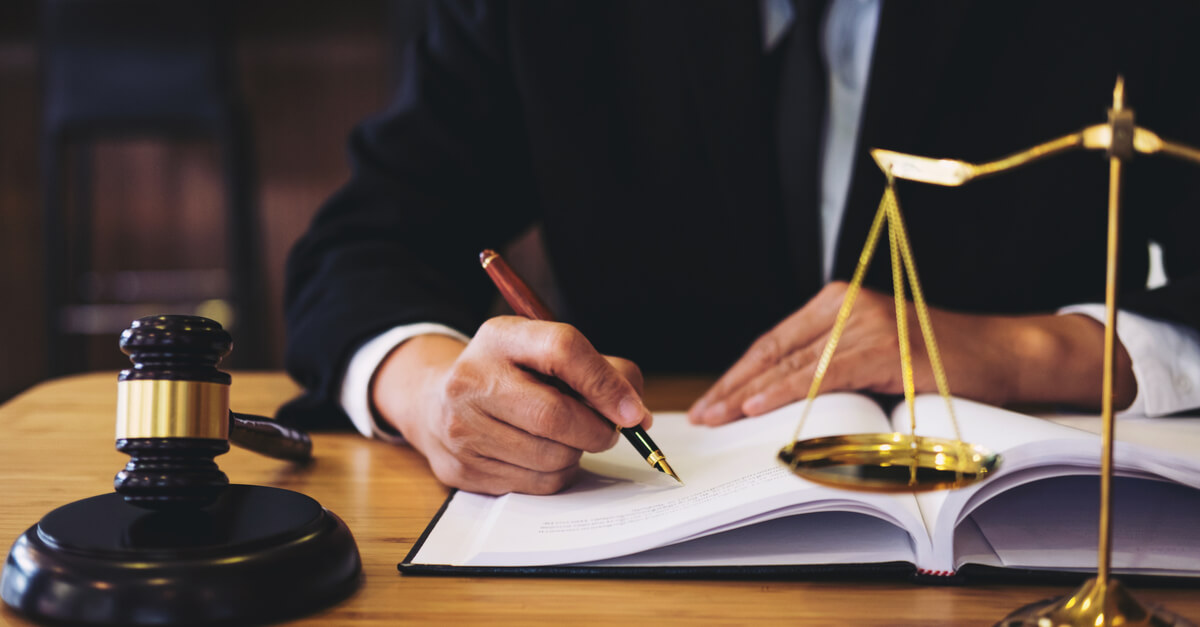 a lawyer signing documents