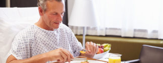 a male hospital patient eats food