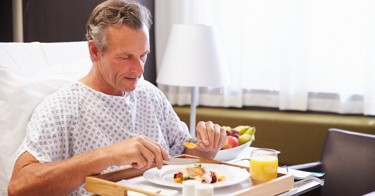 a male hospital patient eats food