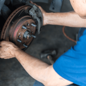 A man works on a car wheel