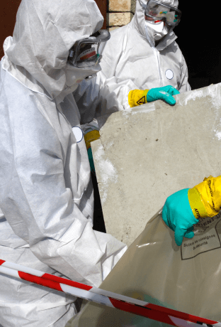 Workers in white hazmat suits work to contain asbestos-related particles