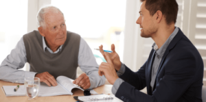 A mesothelioma lawyer speaks with a client at his home