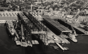 A vintage black and white photo of a Navy shipyard
