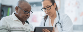 an older male patient has a check up with a female doctor