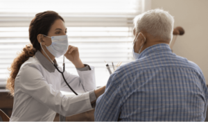 elderly man getting a checkup with a female doctor