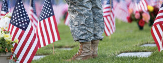 Veteran at cemetery decorated with American flags