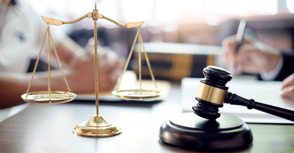 A gavel and scale sit on a table