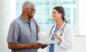 a doctor reassures an older man holding test results
