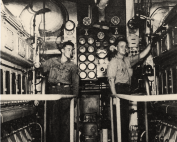 photo of two Navy sailors in cramped working conditions