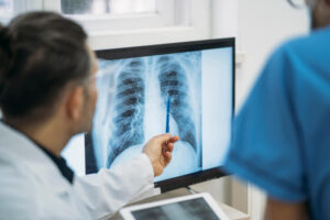 Doctors checking X-rays of a patient's chest.