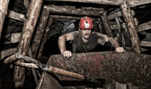 Coal miner pushing cart