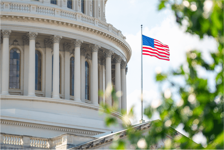 closeup of a U.S. government building with american flag in background