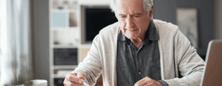 An older man reviews documents
