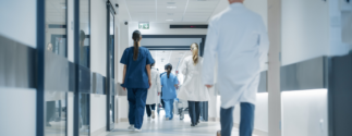 people walking down a hospital
