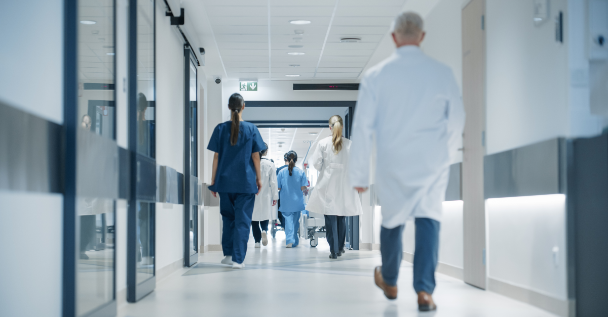 people walking down a hospital