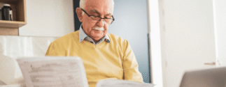 An older man reviews documents