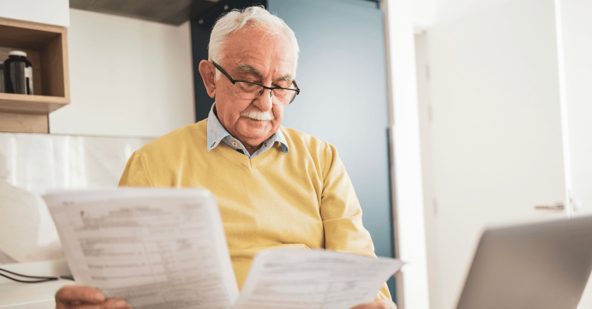 An older man reviews documents